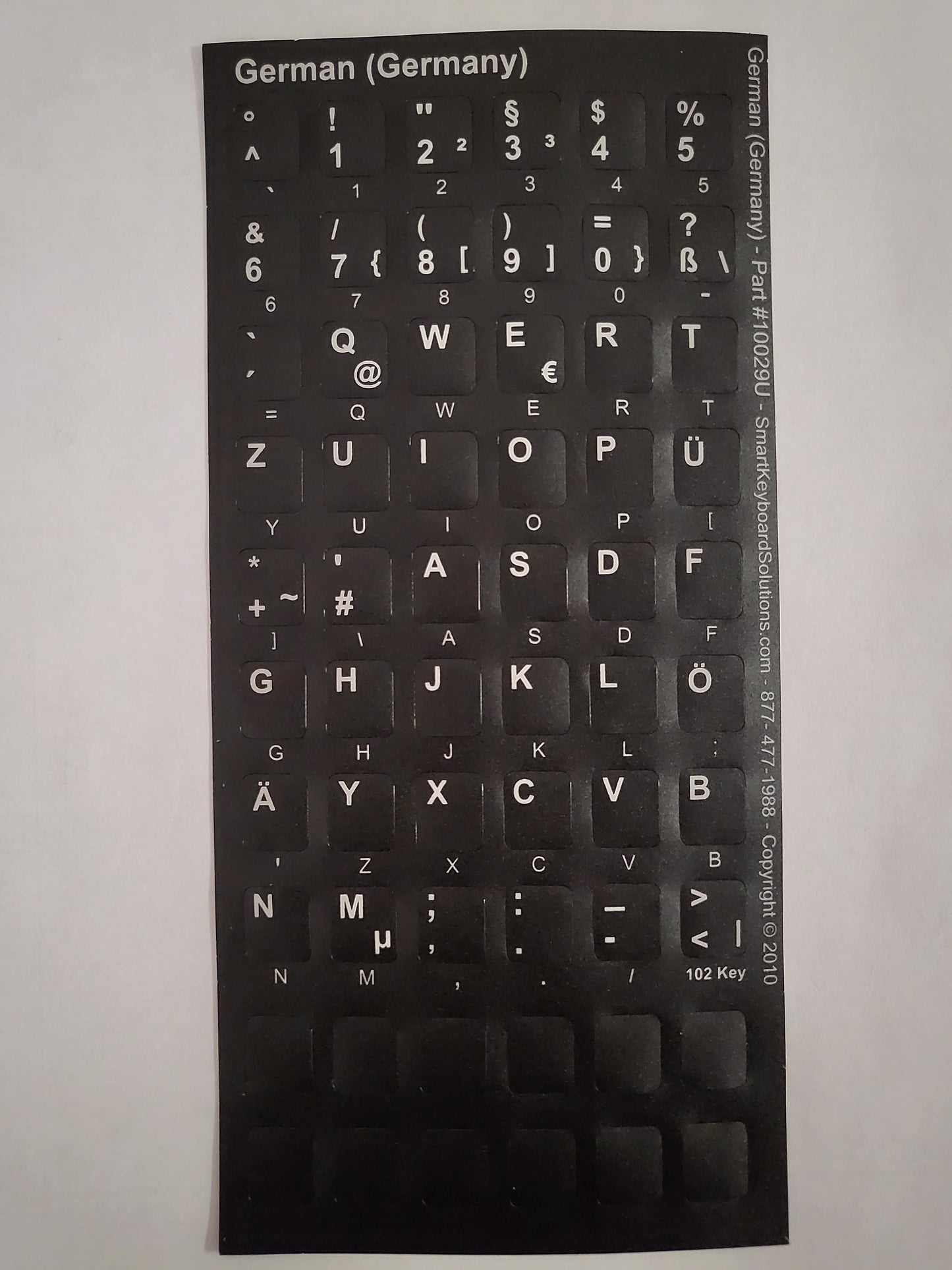 German keyboard label sheet with QWERTY key symbols on black backing