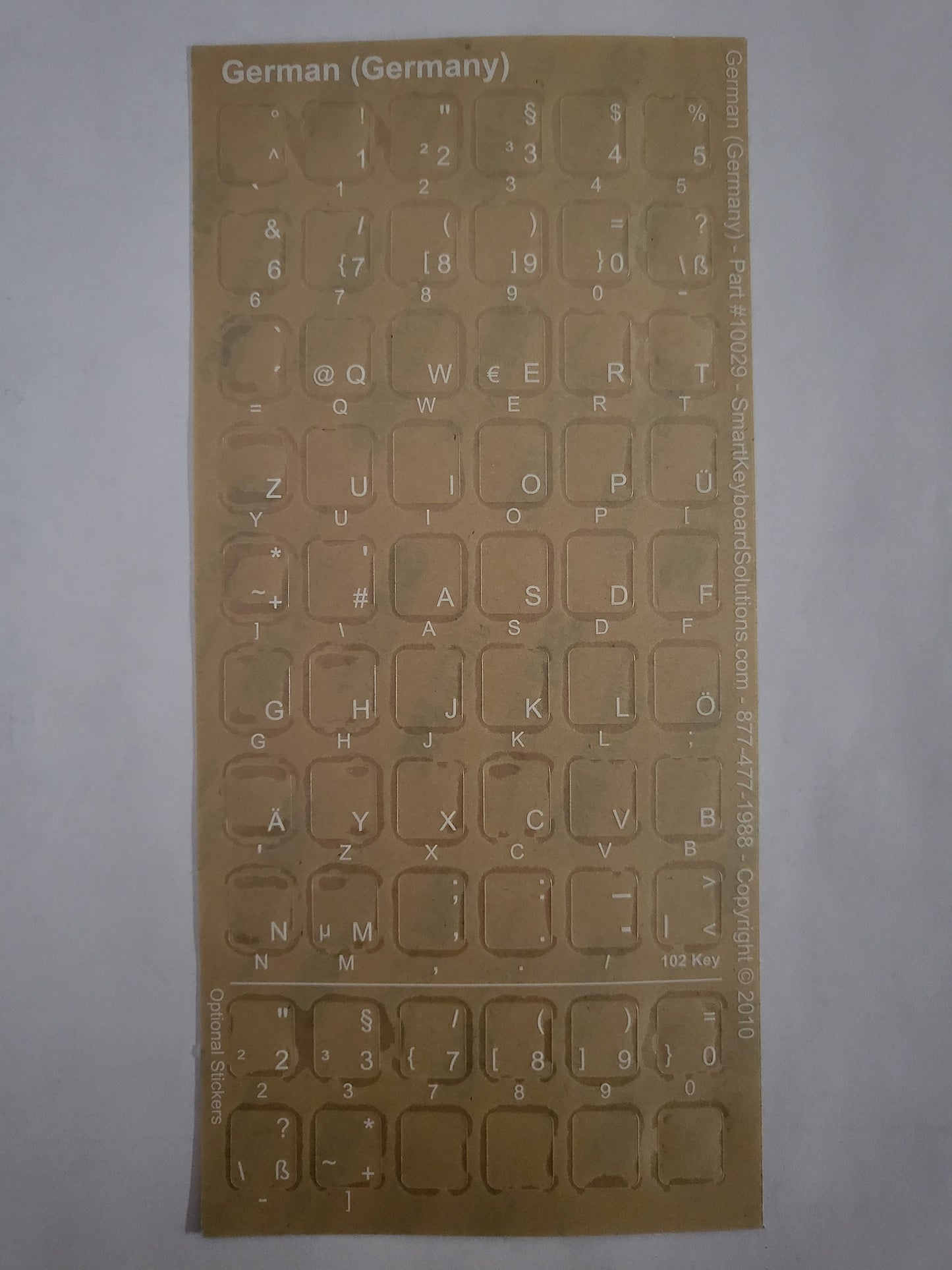German keyboard label sheet with QWERTY key symbols on transparent backing