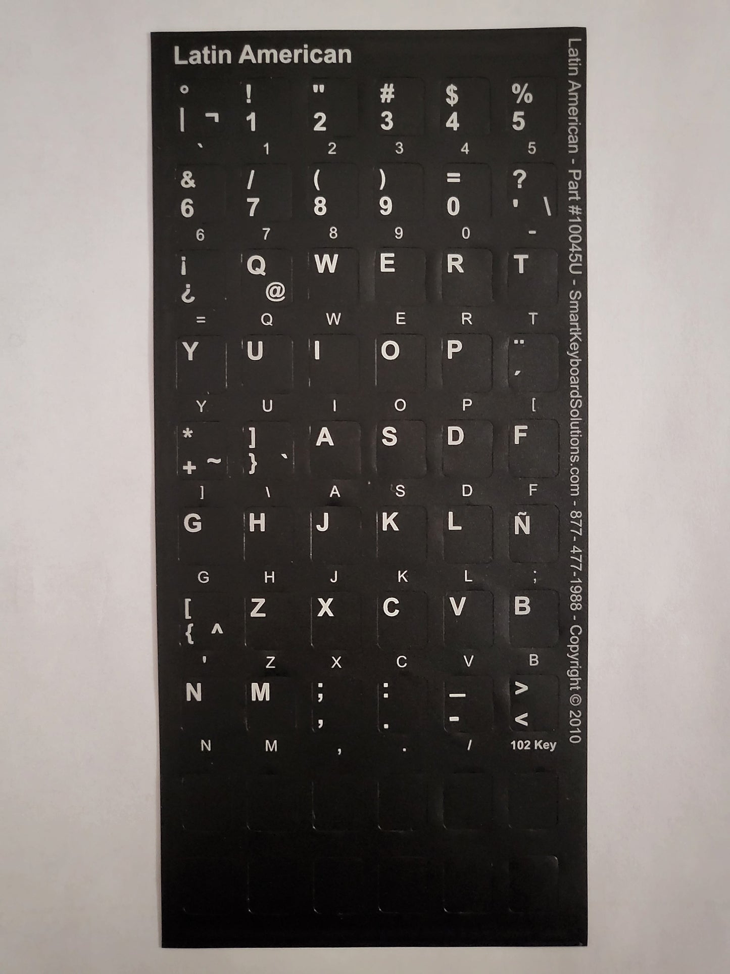 Black keyboard label sheet with white key characters for Latin American layout