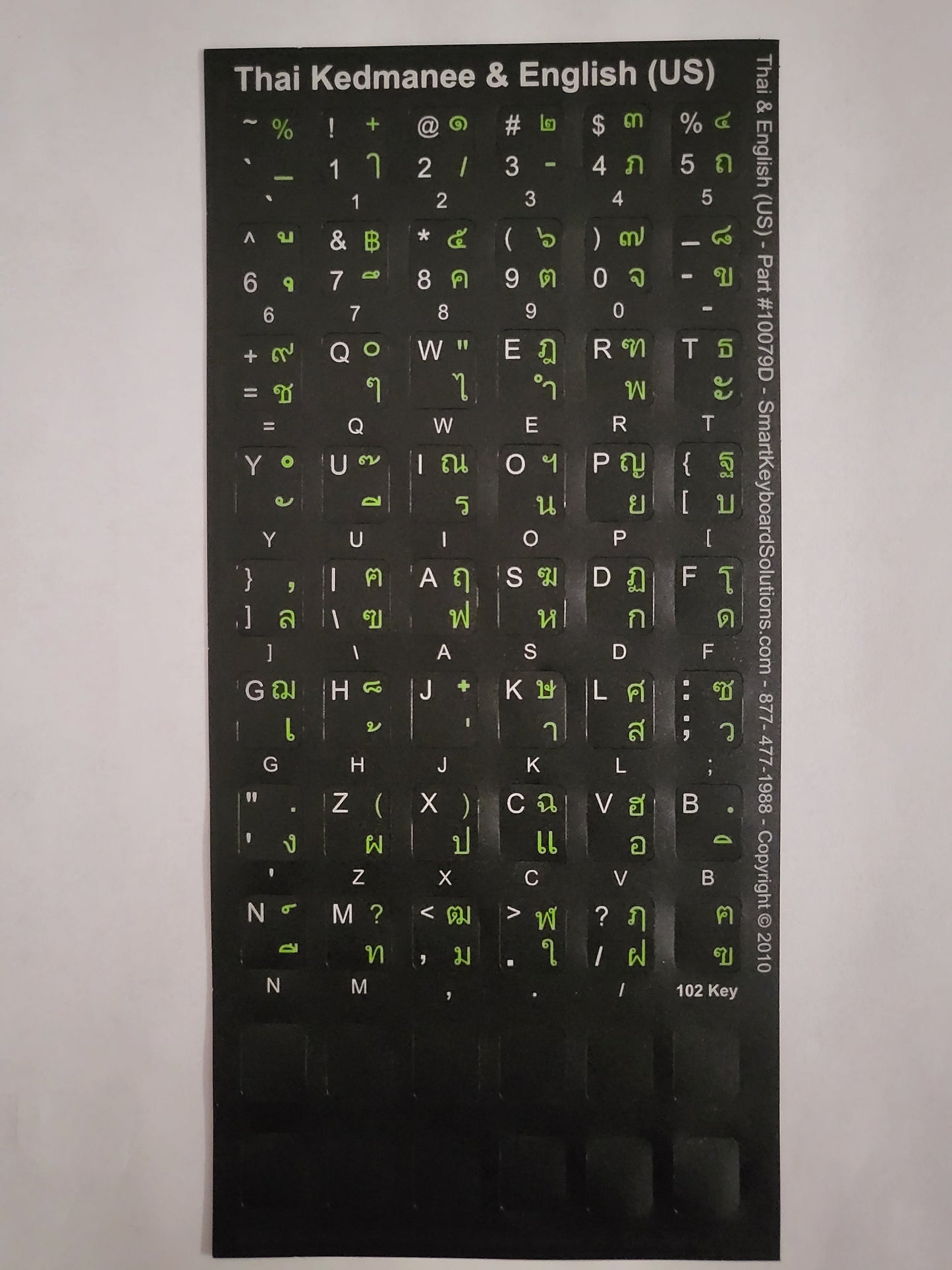 Black keyboard label sheet with Thai and English (US) letters in white and green