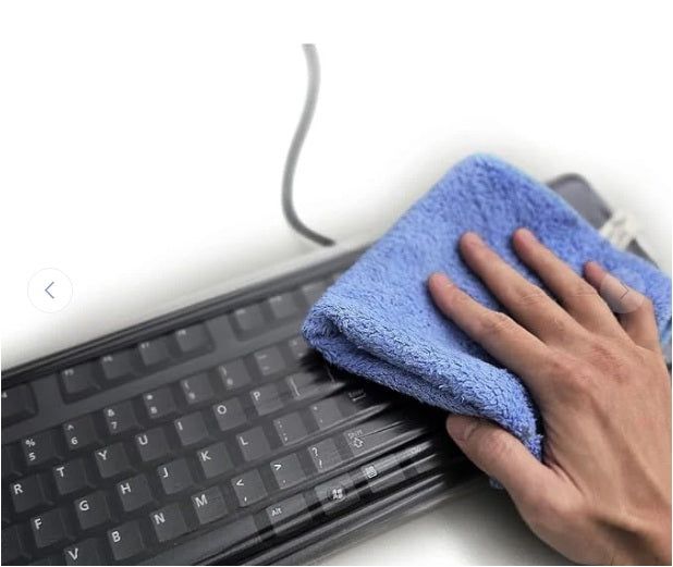 Dark keyboard cover wiped clean with a blue microfiber cloth