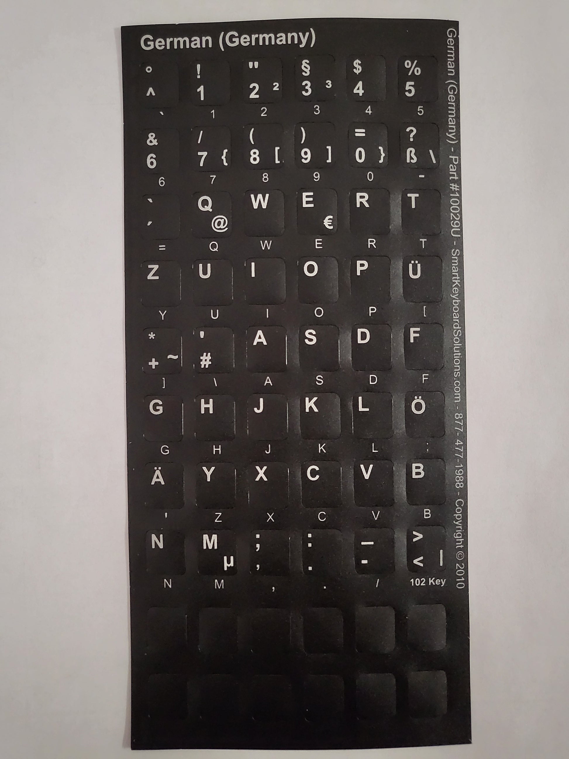 German keyboard label sheet with QWERTY key symbols on black backing
